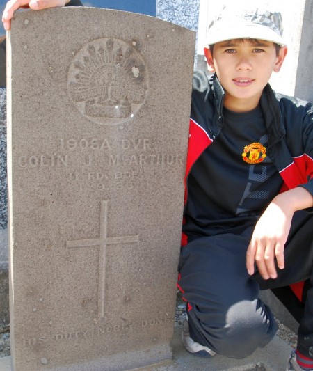 Nicholas beside his great grandfather's grave